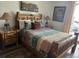 Bedroom with log style bedframe, side tables and comfortable bedding at 34 Highfield Trl # 212, Breckenridge, CO 80424