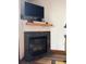 Fireplace with TV, mantle with decor and slate tile at 34 Highfield Trl # 212, Breckenridge, CO 80424