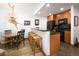 An eat-in kitchen features a breakfast bar, modern appliances, and a dining area with unique rustic decor at 34 Highfield Trl # 212, Breckenridge, CO 80424