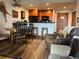 Comfortable living room with wooden floors, kitchen bar, and rustic decor at 34 Highfield Trl # 212, Breckenridge, CO 80424