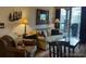 Comfortable living room with couches, chairs and sliding glass doors to a balcony at 34 Highfield Trl # 212, Breckenridge, CO 80424