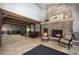 A warm lobby with a stone fireplace and exposed beams welcomes guests to sit and relax at 34 Highfield Trl # 212, Breckenridge, CO 80424