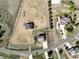 An aerial view shows the home with circular horse track and fencing around the property at 16275 Electra St, Brighton, CO 80603