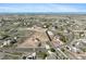 An aerial view shows the home and community with fenced horse property and mountain views at 16275 Electra St, Brighton, CO 80603