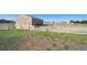 The horse property includes a large barn with fencing and an open area for horses to graze at 16275 Electra St, Brighton, CO 80603