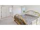 Sunlit bedroom with a view, neutral carpet, and a classic metal-framed bed at 16275 Electra St, Brighton, CO 80603
