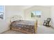 Bright bedroom featuring a large window and a decorative metal-framed bed at 16275 Electra St, Brighton, CO 80603