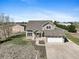 Charming two-story home with a spacious yard, complemented by an attached two-car garage and barn in the background at 16275 Electra St, Brighton, CO 80603