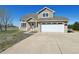 Inviting two-story home featuring an attached two-car garage, well-maintained landscaping, and great curb appeal at 16275 Electra St, Brighton, CO 80603