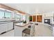 Open-concept kitchen with an island, seamlessly connecting to a cozy dining area, living area, and fireplace at 16275 Electra St, Brighton, CO 80603