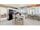 Functional kitchen with an island and a black appliances, complemented by a cozy dining area and lots of windows at 16275 Electra St, Brighton, CO 80603