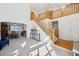 Bright and airy living room featuring an open staircase, high ceilings, and large windows for ample natural light at 16275 Electra St, Brighton, CO 80603