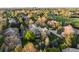 Aerial view of an estate property surrounded by mature trees at 4 Redhawk Run, Englewood, CO 80113