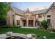 Stately stone home boasts a turret, balconies, lush lawn, and koi pond at 4 Redhawk Run, Englewood, CO 80113