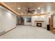 Spacious basement area with a fireplace, staircase, recessed lights, and a dark brown ceiling fan at 4 Redhawk Run, Englewood, CO 80113
