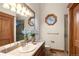 Tastefully decorated bathroom features an octagonal window and wood accents at 4 Redhawk Run, Englewood, CO 80113