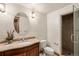 Well-lit bathroom featuring a vanity with double sinks, a shower, and decorative mirror at 4 Redhawk Run, Englewood, CO 80113
