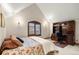 Bedroom with vaulted ceilings, built-in shelves, and comfortable furnishings at 4 Redhawk Run, Englewood, CO 80113