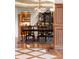 Formal dining room with wood floors, ornate chandelier, and built-in cabinets at 4 Redhawk Run, Englewood, CO 80113