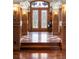 Beautiful foyer with decorative wood trim, stained-glass doors, hardwood floors, and classic design at 4 Redhawk Run, Englewood, CO 80113
