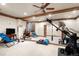 Mirrored wall in a basement gym with ceiling fan and exercise equipment plus a TV on stand at 4 Redhawk Run, Englewood, CO 80113