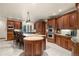 Kitchen with island seating, stainless steel double oven, and granite countertops at 4 Redhawk Run, Englewood, CO 80113