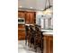 Kitchen island seating with granite counters and stainless steel appliances at 4 Redhawk Run, Englewood, CO 80113