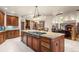 Spacious kitchen with stainless steel appliances, tiled floor, and large island at 4 Redhawk Run, Englewood, CO 80113