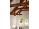 Close-up of the living room wood beams, high ceilings, and arched window at 4 Redhawk Run, Englewood, CO 80113