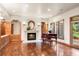 Cozy living room featuring a fireplace, hardwood floors, and elegant décor with natural light at 4 Redhawk Run, Englewood, CO 80113