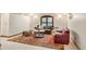 Sunlit living room with decorative area rug, seating, and an arched shuttered window at 4 Redhawk Run, Englewood, CO 80113