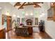 Bright living room with a vaulted ceiling, brick fireplace, hardwood floors, and comfortable seating at 4 Redhawk Run, Englewood, CO 80113