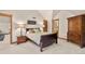 Main bedroom features neutral colors, decorative lamps, and wood trim, with an adjacent bathroom at 4 Redhawk Run, Englewood, CO 80113