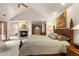 Spacious main bedroom with a fireplace, large windows, and a view into an adjoined space at 4 Redhawk Run, Englewood, CO 80113