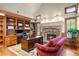 Inviting home office featuring wood bookshelves, a stone fireplace, and a comfortable sitting area at 4 Redhawk Run, Englewood, CO 80113