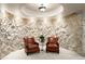Basement sitting area features a stone wall, recessed lighting, and comfortable seating with a plant centerpiece at 4 Redhawk Run, Englewood, CO 80113