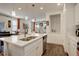 Bright kitchen with stainless appliances, a central island, pendant lights, and hardwood floors at 4754 N Joplin St, Denver, CO 80239