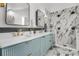 Stunning bathroom featuring a double vanity, sleek fixtures, and a luxurious marble tiled shower at 1406 Pika Rd, Boulder, CO 80302