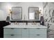 Bright bathroom with dual vanity sinks, black framed mirrors and elegant lighting fixtures at 1406 Pika Rd, Boulder, CO 80302