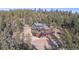 Hillside exterior view of home nestled in the trees with wraparound deck and garage at 1406 Pika Rd, Boulder, CO 80302