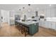 Modern kitchen with stainless steel appliances, large island and hardwood floors at 1406 Pika Rd, Boulder, CO 80302