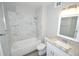 Bright bathroom featuring a tub with marble tile surround and granite vanity at 11937 E Harvard Ave # 101, Aurora, CO 80014