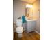 Updated powder room with modern vanity, mirror, and fixtures, complemented by a fresh coat of paint at 19803 Victorian Way, Parker, CO 80138