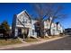 Street view of attractive townhouses, each with unique colors and designs, complemented by mature trees at 19803 Victorian Way, Parker, CO 80138