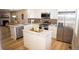 Modern kitchen with stainless steel appliances, granite countertops, a kitchen island, and sleek white cabinetry at 19803 Victorian Way, Parker, CO 80138