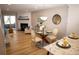 Inviting living and dining area featuring a fireplace, wood floors, and elegant furnishings at 19803 Victorian Way, Parker, CO 80138