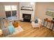 Inviting living room features a fireplace, wood flooring, and sliding glass doors to the backyard at 19803 Victorian Way, Parker, CO 80138