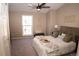 Comfortable main bedroom featuring a ceiling fan, a large window, and neutral decor at 19803 Victorian Way, Parker, CO 80138