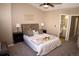 Spacious main bedroom with large lamps on nightstands, a ceiling fan, and attached bathroom at 19803 Victorian Way, Parker, CO 80138