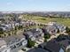 Aerial view of townhomes with shared green space and a city skyline backdrop at 5399 Valentia St, Denver, CO 80238